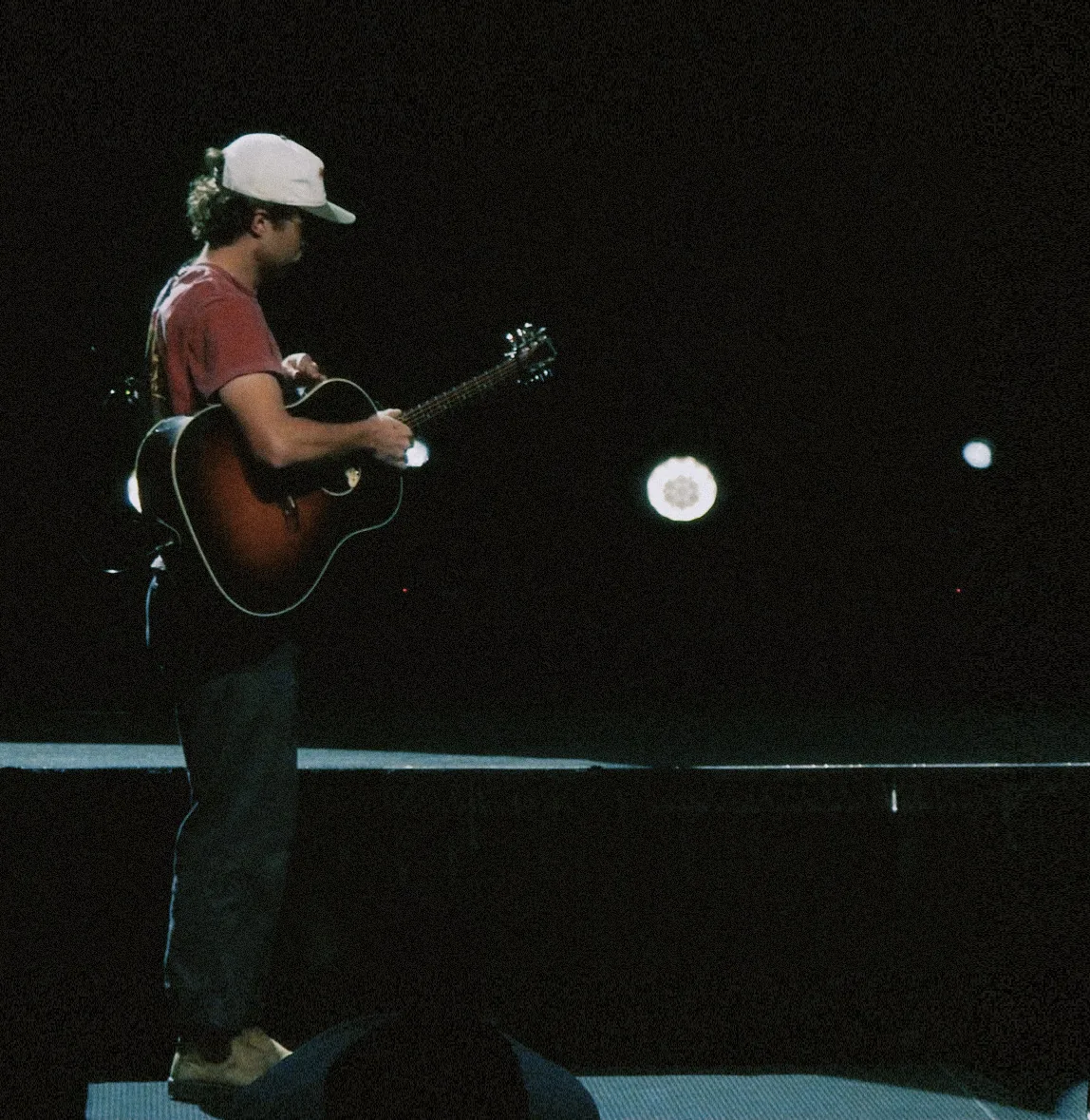 Quincy leading worship on a dark stage